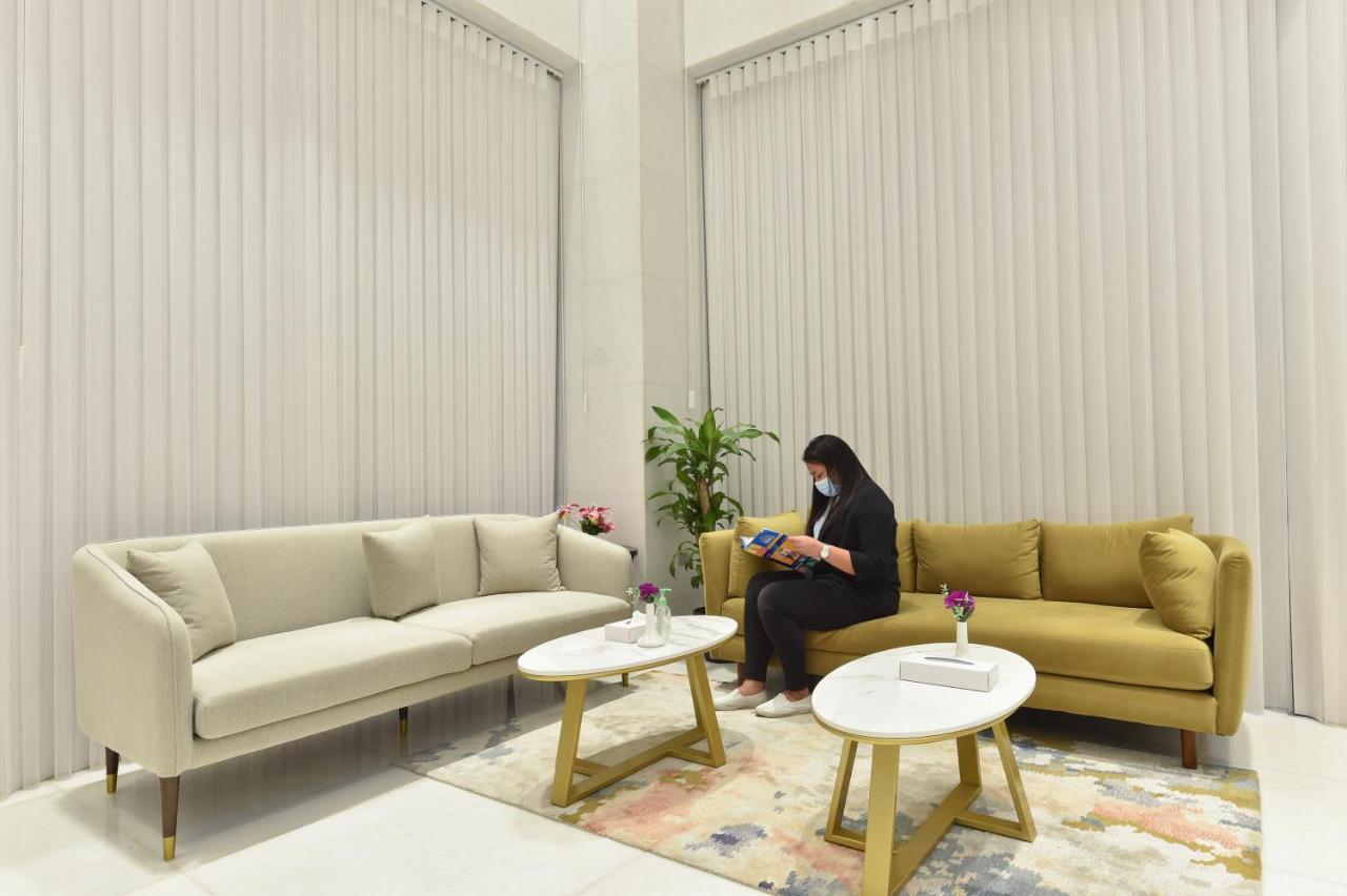 Saray Deluxe Hotel Apartments Abu Dhabi Exterior photo A woman in Dubai wearing a face mask
