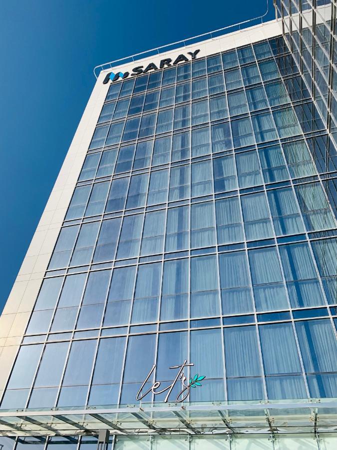 Saray Deluxe Hotel Apartments Abu Dhabi Exterior photo The glass facade of the building
