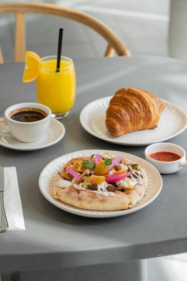 Saray Deluxe Hotel Apartments Abu Dhabi Exterior photo A croissant and orange juice