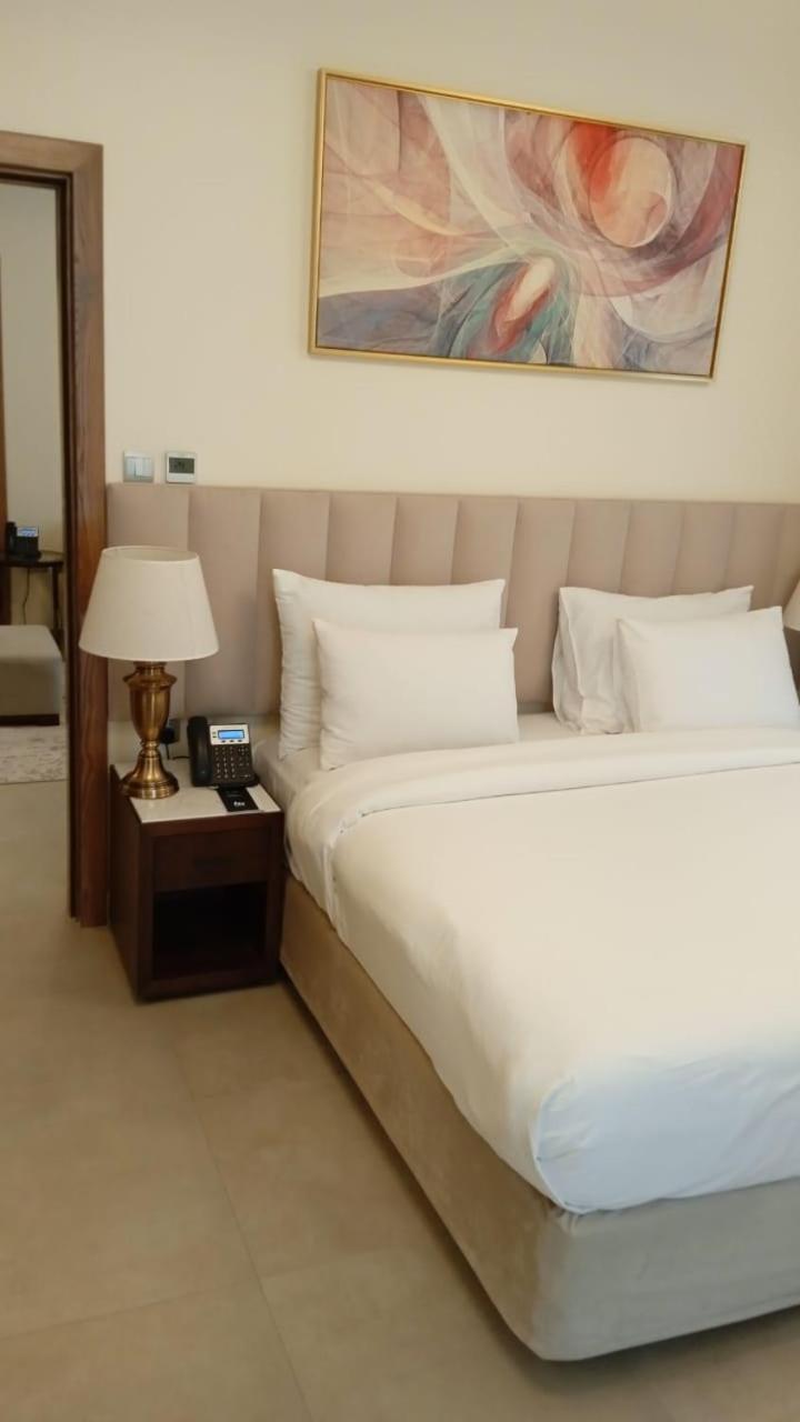 Saray Deluxe Hotel Apartments Abu Dhabi Exterior photo A telephone on a bedside table